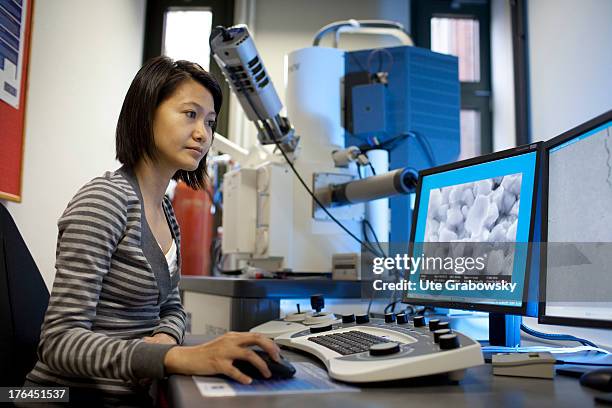 PhD student in front of the scanning electron microscope during the investigation of mechanical properties of enamel and composite materials, A new...