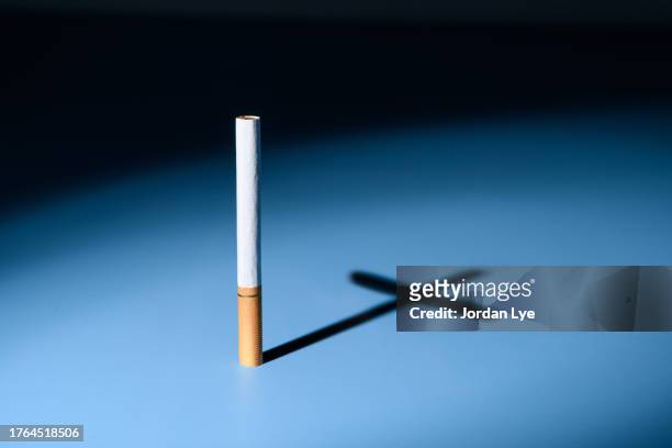 cross made out of cigarettes shadow - smoking death stock pictures, royalty-free photos & images