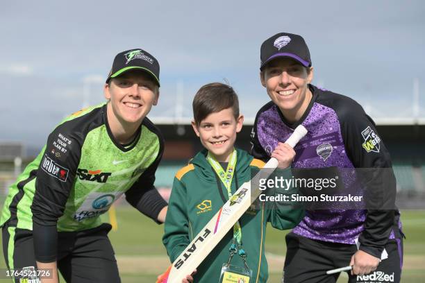 Team captains Heather Knight of the Thunder and Elyse Villani of the Hurricanes pose for a photo with Evan Paul during the bat flip ahead of WBBL...