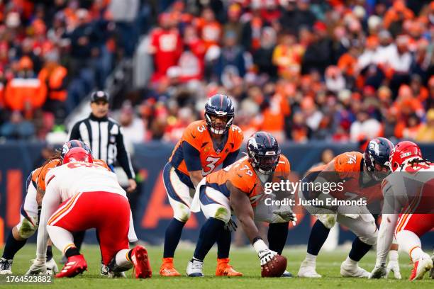 Quarterback Russell Wilson of the Denver Broncos lines up under center Lloyd Cushenberry during the fourth quarter against the Kansas City Chiefs at...