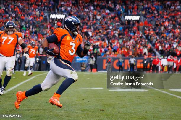 Quarterback Russell Wilson of the Denver Broncos runs with the football during the fourth quarter against the Kansas City Chiefs at Empower Field at...