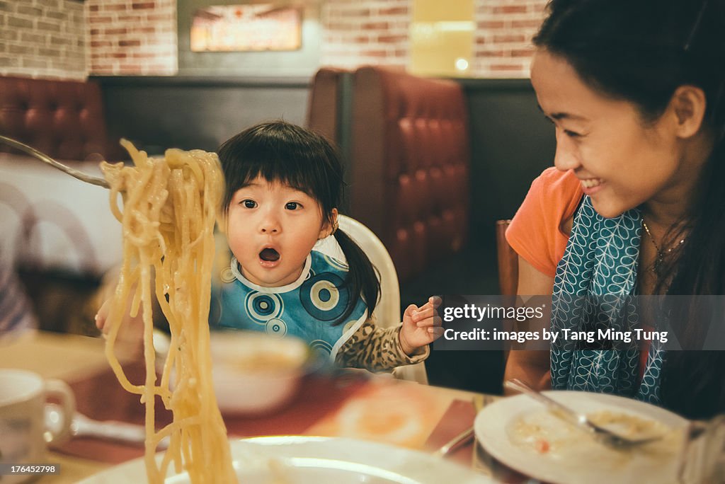 Family sharing spaghetti in a restaurant