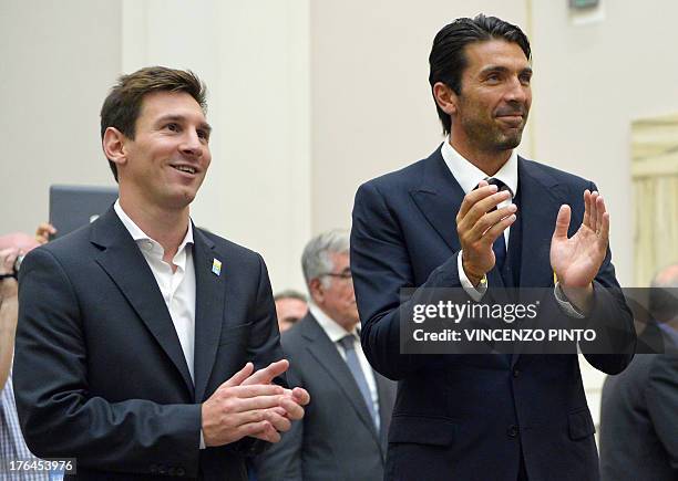 Argentina's national football team forward Lionel Messi and Italy's national football team captain Gianluigi Buffon applaud during a humanity...