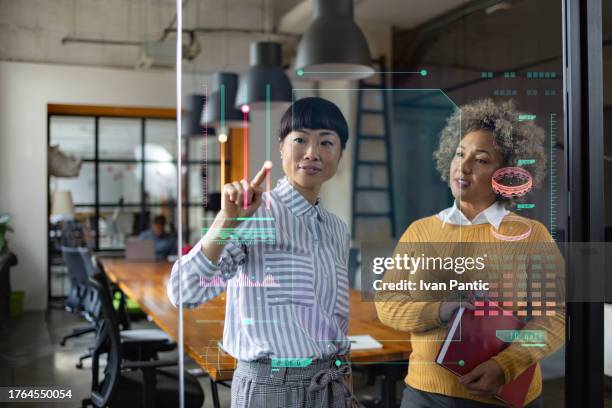 business colleagues working on graphical user interface in the office. - holograma imagens e fotografias de stock