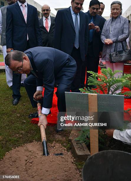 Secretary-General Ban Ki-moon plants a tree at the Islamabad College for Girls in Islamabad on August 13, 2013. UN chief Ban Ki-moon arrived in...