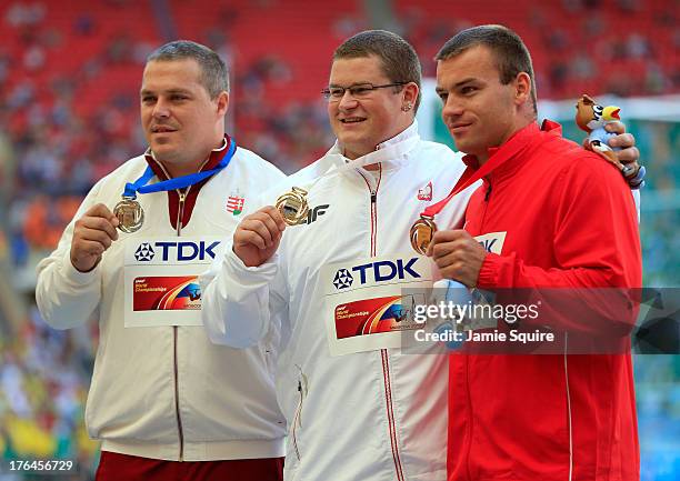 Silver medalist Krisztian Pars of Hungary, gold medalist Pawel Fajdek of Poland and bronze medalist Lukas Melich of the Czech Republic stand on the...