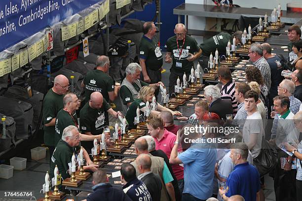 Beer drinkers queue at a bar at the Great British Beer Festival in the Olympia exhibition centre on August 13, 2013 in London, England. The festival,...