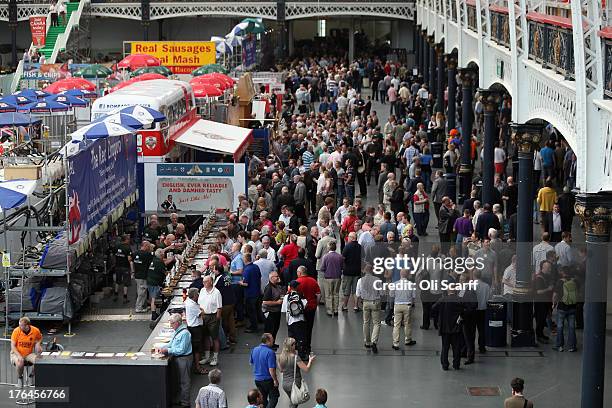 Beer drinkers queue at a bar at the Great British Beer Festival in the Olympia exhibition centre on August 13, 2013 in London, England. The festival,...