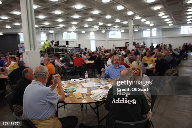 Drinkers sit and chat at the Great British Beer Festival in the Olympia exhibition centre on August 13, 2013 in London, England. The festival, which...