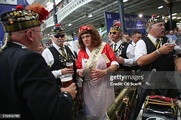 Men promoting 'Betty Stogs' Cornish ale take a break to enjoy their drinks at the Great British Beer Festival in the Olympia exhibition centre on...