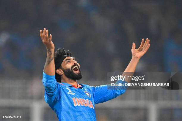 India's Ravindra Jadeja reacts as he takes the catch to dismiss South Africa's Kagiso Rabada during the 2023 ICC Men's Cricket World Cup one-day...