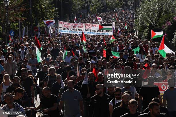 People, holding banners and Palestinian flags, attend a Pro-Palestinian demonstration in Athens, Greece on November 05, 2023.