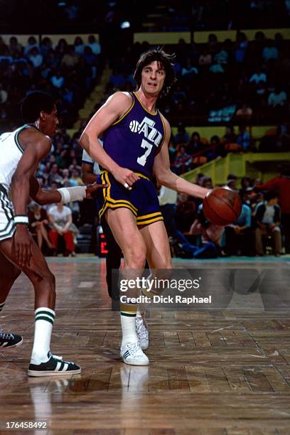Pete Maravich of the Utah Jazz dribbles the ball against the Boston Celtics during a game played circa 1977 at the Boston Garden in Boston,...