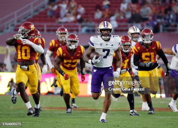 Washington Huskies running back Dillon Johnson outruns the USC defense for extra yardage in the first half at L.A. Memorial Coliseum November 4, 2023...