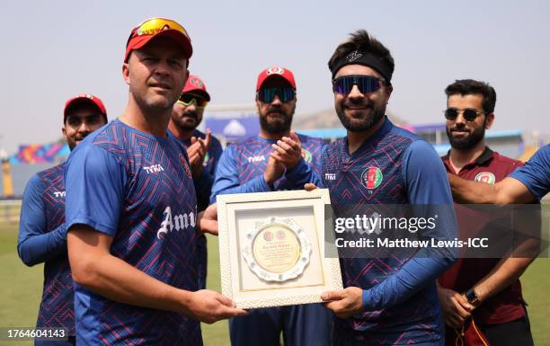 Rashid Khan of Afghanistan is presented with a memento by Jonathan Trott, Head Coach of Afghanistan as they prepare to play their 100th ODI ahead of...