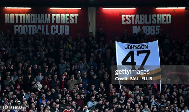 Fans hold aloft a tribute to Adam Johnson, the Nottingham Panthers Ice Hockey player who died after his throat was cut by an ice skate blade during a...