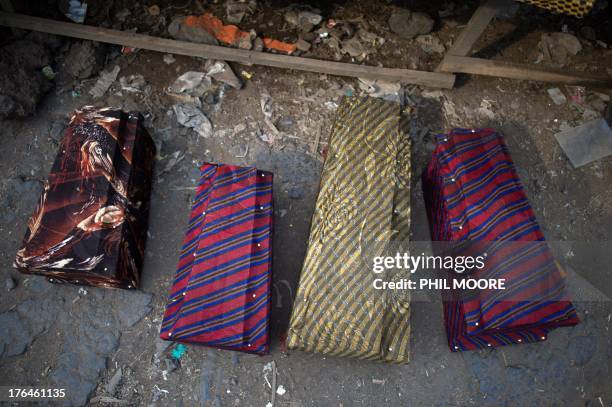 Coffins for young children lay on the ground at a stall selling coffins in Goma in the east of the Democratic Republic of Congo on August 13, 2013....