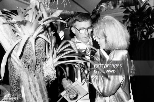 Roddy McDowall and Angie Dickinson attend a party in Beverly Hills, California, on June 25, 1987.