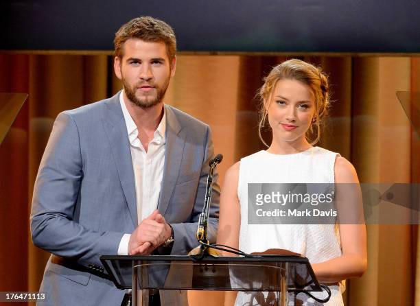 Actors Liam Hemsworth and Amber Heard speak onstage at the Hollywood Foreign Press Association's 2013 Installation Luncheon at The Beverly Hilton...