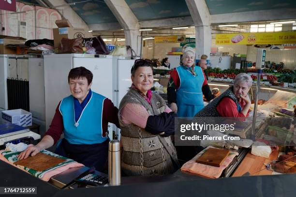 Vendors in the local market are depicted as local residents cast their ballots to choose mayors and municipal councils in the local elections on...