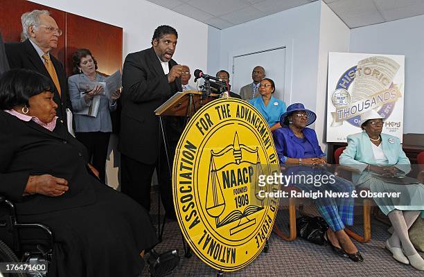 The Rev. William Barber, head of the N.C. NAACP, at podium, announces that the group is filing a lawsuit against the recently passed Voter ID bill...