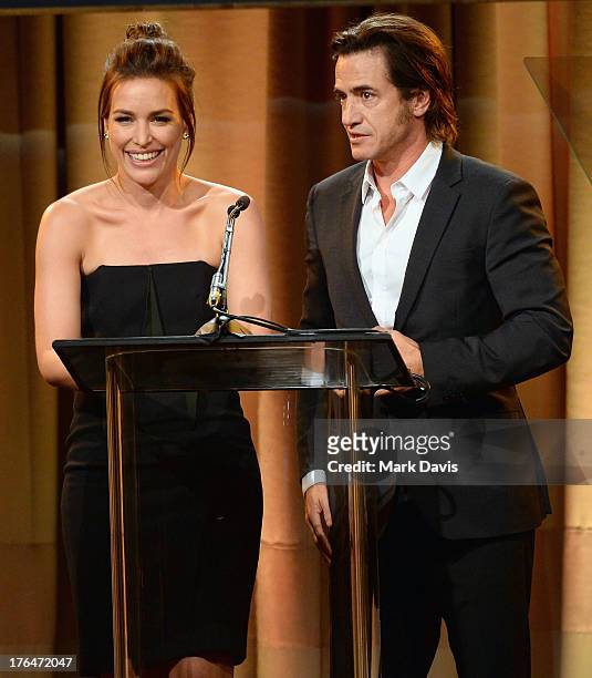 Actors Piper Perabo and Dermot Mulroney speak onstage at the Hollywood Foreign Press Association's 2013 Installation Luncheon at The Beverly Hilton...