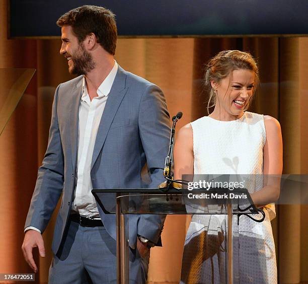 Actors Liam Hemsworth and Amber Heard speak onstage at the Hollywood Foreign Press Association's 2013 Installation Luncheon at The Beverly Hilton...