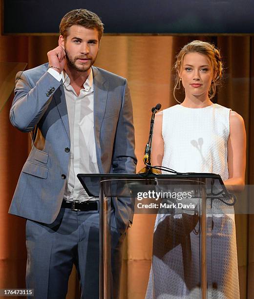 Actors Liam Hemsworth and Amber Heard speak onstage at the Hollywood Foreign Press Association's 2013 Installation Luncheon at The Beverly Hilton...