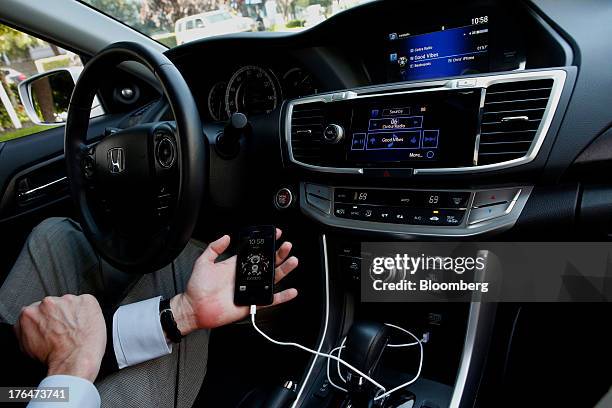 The Pandora Media Inc. Integrated entertainment system is demonstrated with an Apple Inc. IPhone 5 inside a Honda Accord vehicle at American Honda...