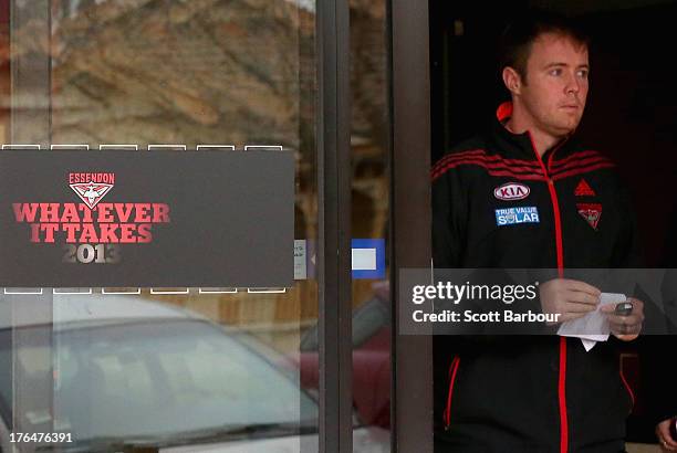 An Essendon Bombers staff member leaves the Bombers Head Office at Windy Hill on August 14, 2013 in Melbourne, Australia. The AFL last night...