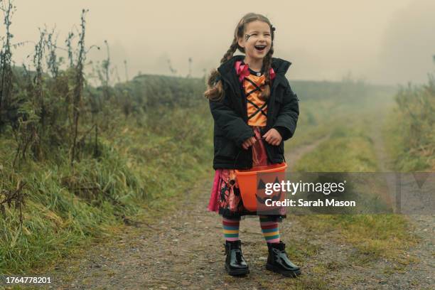 little girl dressed as a witch for halloween laughing - cleaning equipment stock pictures, royalty-free photos & images