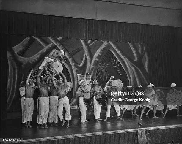 Costumed drummers and dancers performing in Katherine Dunham's 'A Caribbean Rhapsody' at the Prince of Wales Theatre in London, June 1948. Among...