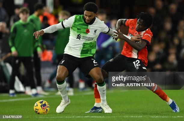 Luton Town's Burkinese defender Issa Kabore vies with Liverpool's English defender Joe Gomez during the English Premier League football match between...