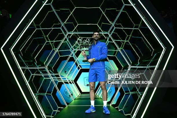 Serbia's Novak Djokovic poses with the trophy after winning the men's singles final match of the Paris ATP Masters 1000 tennis tournament against...