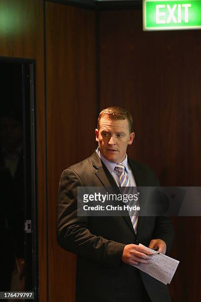 Former Lions coach Michael Voss arrives at a Brisbane Lions AFL media conference at The Gabba on August 14, 2013 in Brisbane, Australia. The Lions...