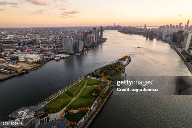 aerial view of roosevelt island at sunset manhattan, new york - roosevelt island stock pictures, royalty-free photos & images