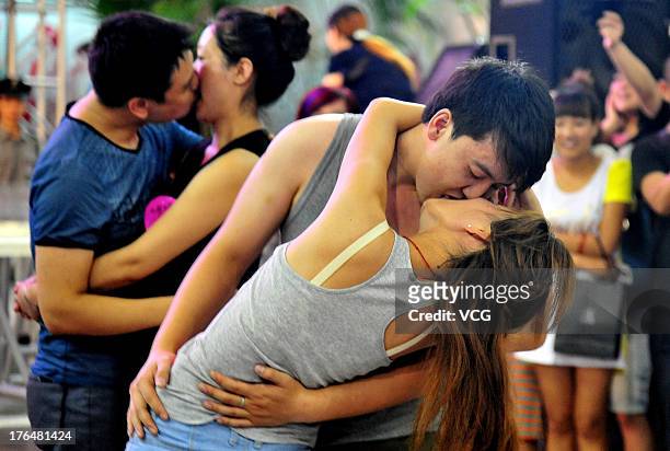 Chinese lovers kiss during a competition to greet the Chinese Valentine's Day on August 13, 2013 in Shenyang, China. The Chinese Valentine's Day...