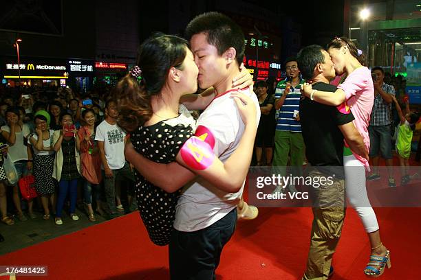 Chinese lovers kiss during a competition to greet the Chinese Valentine's Day on August 13, 2013 in Nantong, China. The Chinese Valentine's Day falls...