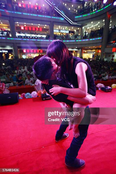 Chinese lovers kiss during a competition to greet the Chinese Valentine's Day on August 13, 2013 in Quanzhou, China. The Chinese Valentine's Day...