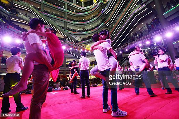 Chinese lovers kiss during a competition to greet the Chinese Valentine's Day on August 13, 2013 in Quanzhou, China. The Chinese Valentine's Day...