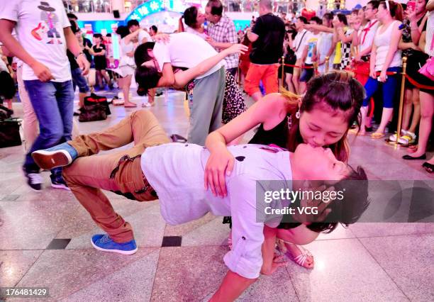 Chinese lovers kiss during a competition to greet the Chinese Valentine's Day on August 13, 2013 in Shenyang, China. The Chinese Valentine's Day...