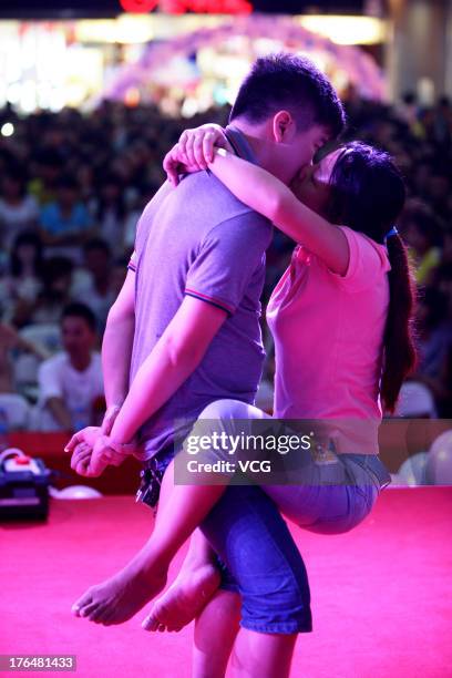 Chinese lovers kiss during a competition to greet the Chinese Valentine's Day on August 13, 2013 in Quanzhou, China. The Chinese Valentine's Day...