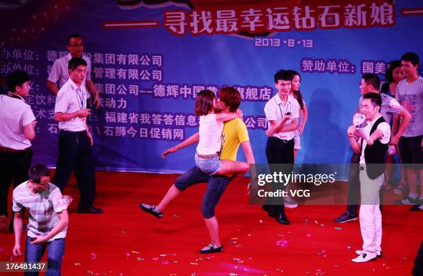 Chinese lovers kiss during a competition to greet the Chinese Valentine's Day on August 13, 2013 in Quanzhou, China. The Chinese Valentine's Day...