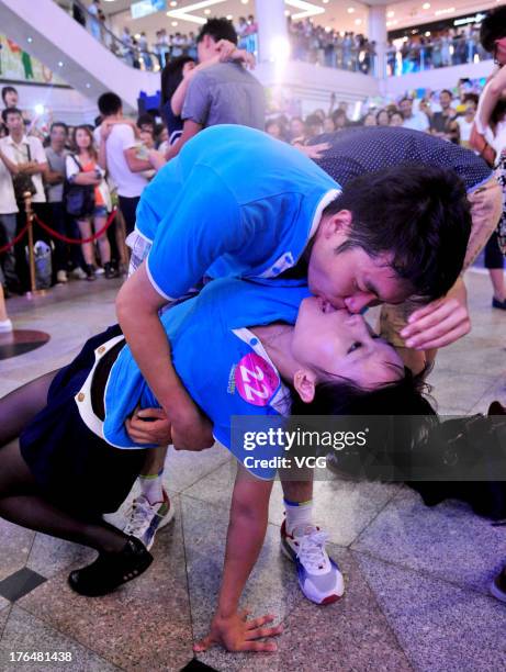 Chinese lovers kiss during a competition to greet the Chinese Valentine's Day on August 13, 2013 in Shenyang, China. The Chinese Valentine's Day...