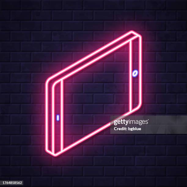 isometric tablet pc - horizontal position. glowing neon icon on brick wall background - touch screen wall stock illustrations