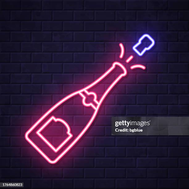 champagne explosion. glowing neon icon on brick wall background - exploding wall stock illustrations