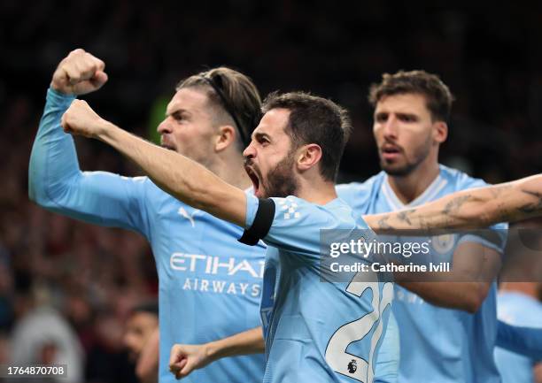 Bernardo Silva celebrates with team mates during the Premier League match between Manchester United and Manchester City at Old Trafford on October...