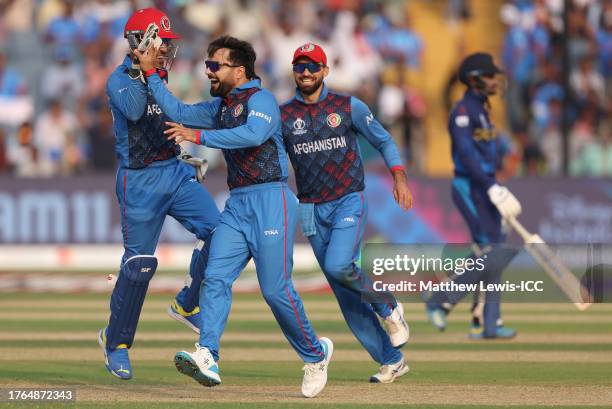 Rashid Khan of Afghanistan celebrates the wicket of Dhananjaya de Silva of Sri Lanka during the ICC Men's Cricket World Cup India 2023 between...