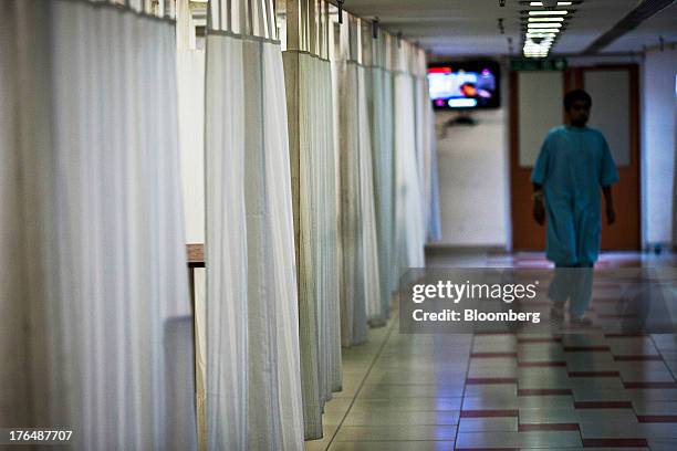 Patient walks through a general ward of the Indraprastha Apollo Hospitals facility, operated by Apollo Hospitals Enterprise Ltd., in New Delhi,...