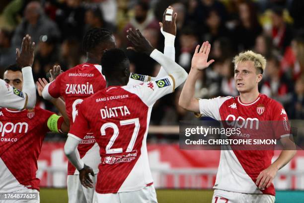 Monaco's Russian midfielder Aleksandr Golovin celebrates scoring his team's second goal with teammates during the French L1 football match between AS...